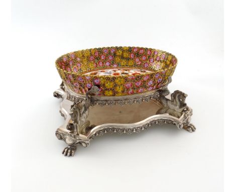 A late Victorian electroplated centre-piece, shaped rectangular form, the pierced oval gallery frame supported by four hippoc