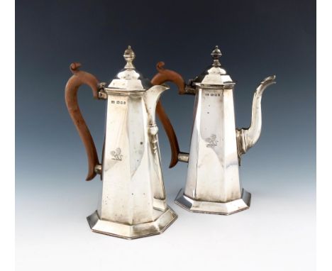 A pair of silver cafe au lait pots, by Carrington and Co, London 1923, tapering octagonal form, scroll handles, domed cover, 