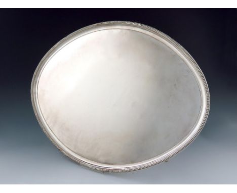 A large George III old Sheffield plated salver, circa 1790, oval form, beaded border, on four fluted bracket feet, length 50.