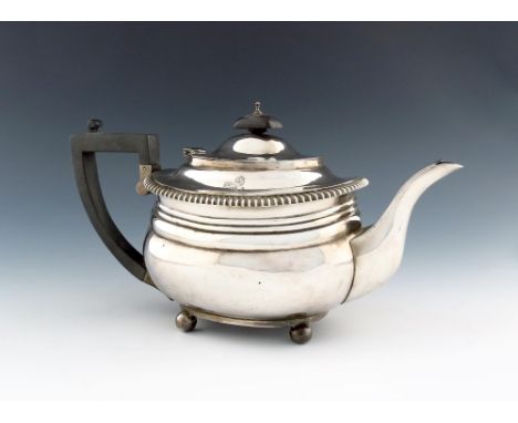 A silver teapot, by The Goldsmiths and Silversmiths Company, London 1923, oblong bellied form, gadroon borders, engraved with