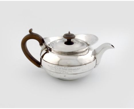 A George III silver teapot, by J Storey and W. Elliott, London 1812, circular cape form, scroll handle, flush-hinged cover, w