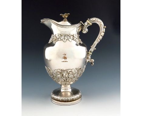 λ An early 19th century old Sheffield plated wine jug /ewer, baluster form, with trailing grapevine tendrils, leaf capped scr