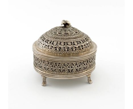 An Indian metal ware pot and cover, marked silver, circular form, pierced and chased with foliate decoration, the pull-off co