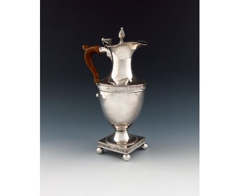 A George III old Sheffield plated hot water jug, circa 1780-85, vase form, scroll handle, the hinged cover with a cone finial