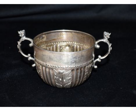 VICTORIAN SILVER MUG Stands 6.0cm high, decorated with embossed Acanthus leaves, scroll and griffin handles, hallmarked Londo
