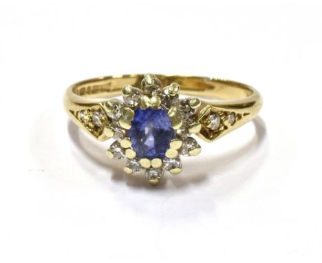 9CT GOLD CEYLON SAPPHIRE &amp; DIAMOND RING An oval cut Ceylonese, cornflower blue sapphire, estimated 0.43 carats, surround 