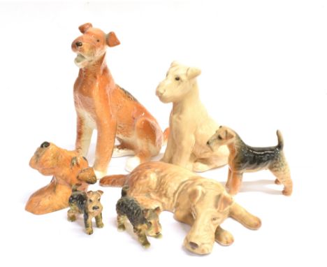 SEVEN CERAMIC AIREDALE TERRIER ORNAMENTS including one by Sylvac, 18cm long; and one by Beswick, 10cm long. Condition Report 