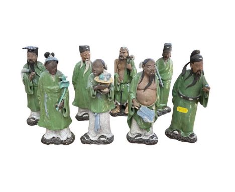 Set of eight Chinese pottery figures of Immortals, with green glazed robes, approx 21cm high