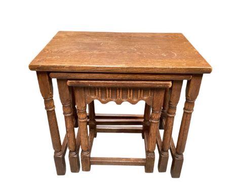 Oak nest of three occasional tables and a mahogany standard lamp (2)