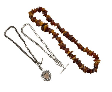 Two Edwardian silver curb link watch chains, one with a silver and gold fob, together with an amber necklace (3)