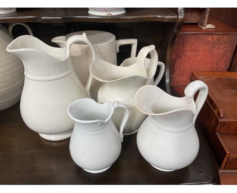 Group of six various white glazed ceramic jugs. 