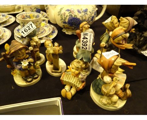 Nine Hummel / Goebel figurines, A/F CONDITION REPORT: All figurines have small and minor damages, for example the skier just 