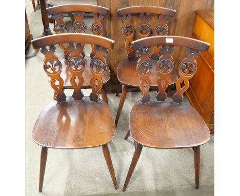 A set of four Ercol Golden Dawn elm and beech fleur de lys chairs 