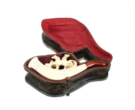 A Meerschaum cigarette holder in the form of a pipe, with equestrian decoration, in original case