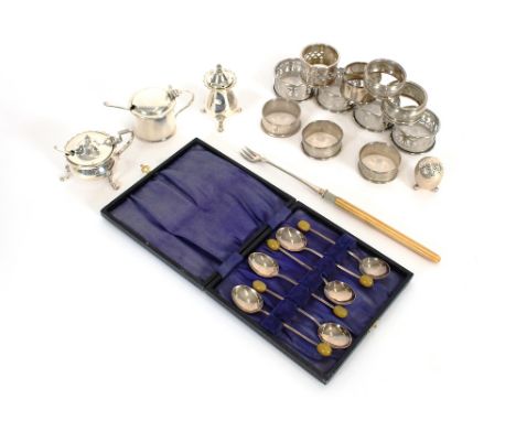A collection of various silver and plated napkin rings; a silver drum shaped mustard pot; a silver pepperette; plated cruet i