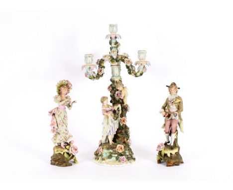 A Sitzendorf floral encrusted candelabra, 50cm high; and a pair of similar porcelain figures of a minstrel and attendant beau