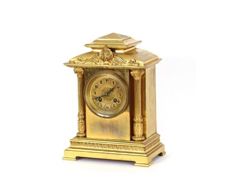 A 19th Century gilded brass mantel clock, of architectural form, circular enamel dial with filigree decoration, flanked by co