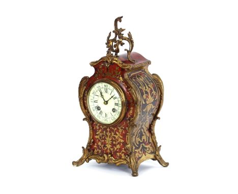 A French tortoise shell and cut brass inlaid mantel clock, in the manner of Boulle, with circular enamelled Roman dial suppor