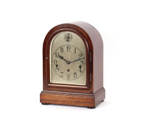 An early 20th Century mahogany cased chiming mantel clock, having silvered dial, striking on a gong, 36cm high