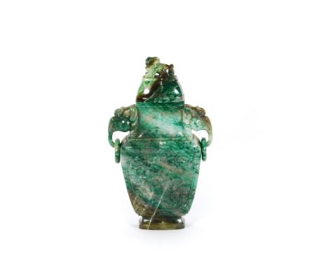A Chinese mottled green jade carved vase, and cover, flanked by elephant head and ring handles, 22cm high