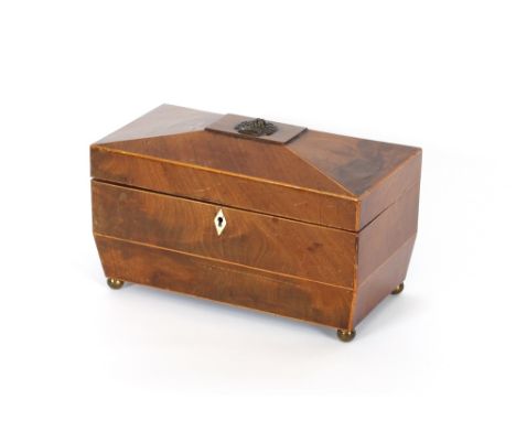 A Regency mahogany and boxwood strung three compartment tea caddy, of sarcophagus form, raised on brass ball feet, 28cm