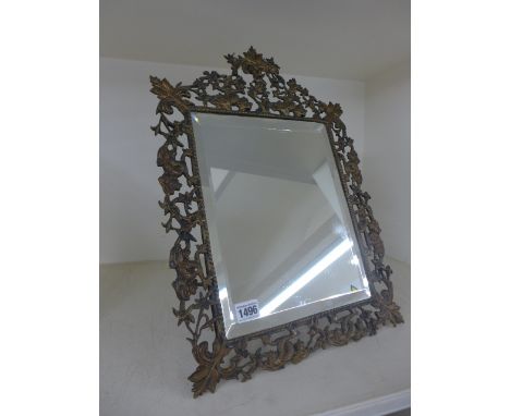 An ornate bronze easel back mirror decorated with entwined dolphins - 49cm x 35cm - overall good, some slight bending