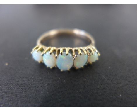 A five stone opal ring believed to be 9ct gold - ring size N - approx weight 2.6 grams - signs of re sizing, stones bright