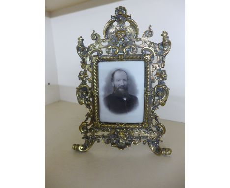 An ornate bronze easel back frame - 32cm x 21cm - some bending and old repairs
