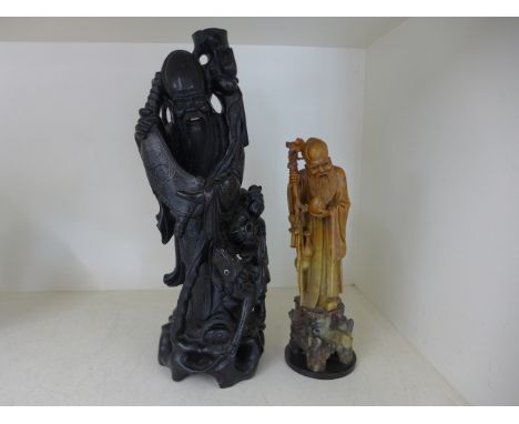An ebony Oriental lamp base of figural design with silver inlay and a soapstone figural Oriental figure - Height 44cm and 32c