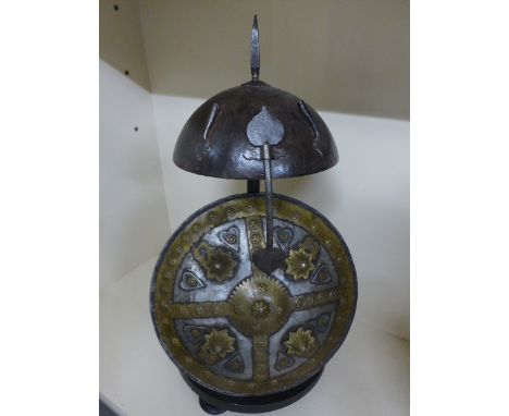A metalwork antique Persian helmet and a copy shield on a presentation stand - Helmet diameter 22cm, Shield diameter 30cm