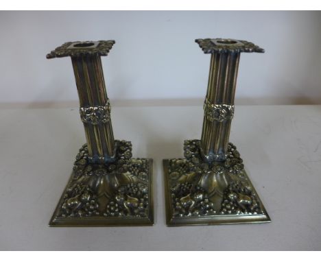 A pair of French brass candlesticks covered in foliate and floral design with putti to each corner of base - Height 21cmCondi