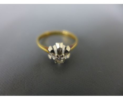 An 18ct yellow and white gold diamond solitaire ring size K 1/2 - approx weight 2.8 grams, diamond approx 1/8ct - clean and b