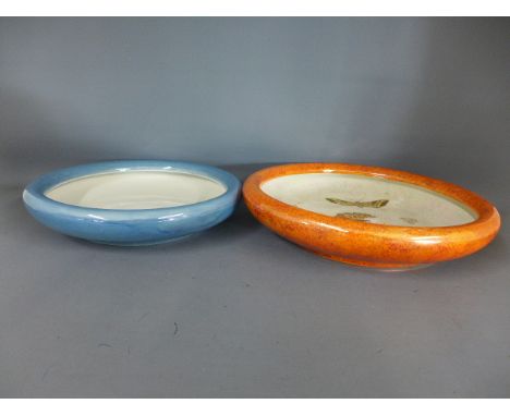A Carltonware lustre bowl decorated with butterflies with rust coloured field and one smaller without decoration with blue fi