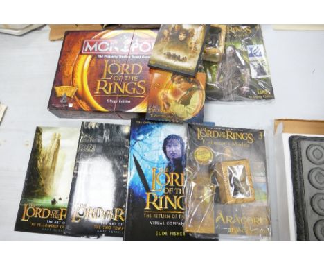 A collection of Lord of The Rings items to include: Monopoly set, magazines, Display Stand etc 