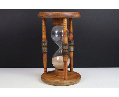 Large glass egg timer, the frame formed from an old wooden weaving bobbin, 30cm high