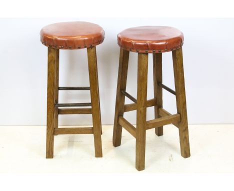 Pair of vintage oak stools with leather upholstered seats 