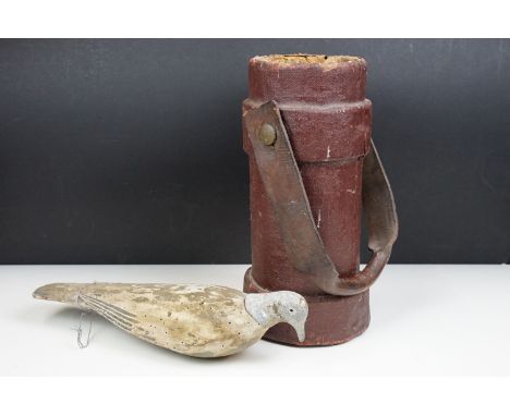 Vintage folk art decoy pigeon together with an antique crested military gun powder cordite artillery shell carrier leather bu