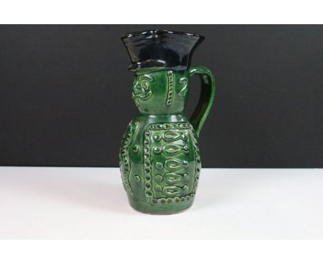Hungarian Folk Art green glazed wine pitcher in the form of a soldier, 20cm high