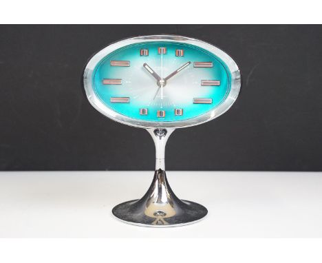 Mid century Japanese space age alarm clock, the oval blue dial held within a chrome and plastic footed case, 19cm high