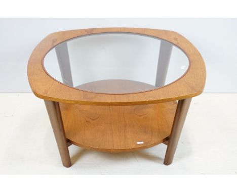 Mid century retro teak coffee table of square form with rounded sides, the top with inset glass panel, shelf below, 70cm wide
