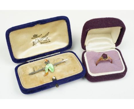 A vintage rose gold coloured ladies ring with central amethyst stone together with a silver and enamel bar brooch. 