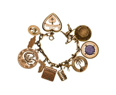 14k and 10k Yellow Gold Charm Bracelet  An oval-link style bracelet having twelve attached charms (some marked '14k' / '10k')