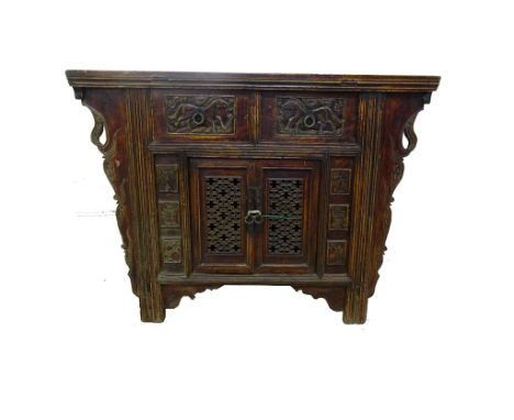 An early Twentieth Century Chinese red lacquered console or altar table: With rectangular top, the front fitted with two door