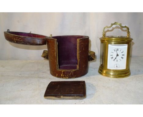 A 19th C French Grand Sonnerie Quarter repeater Carriage Clock:
an oval brass case with quarter repeating and alarm mechanism