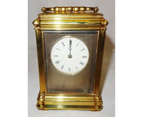 A 19th century brass repeater carriage clock.
Brass case with engine turned silvered dial, Roman numerals and Beetle and Poke