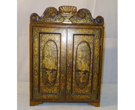 A Chinese Black Lacquered Table Top Cabinet:
Late 19th/early 20th century
The two external doors and the sides decorated in g