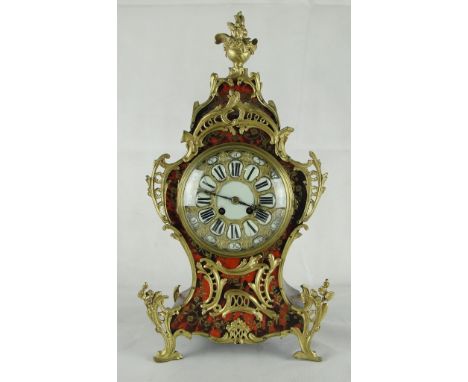 A 19th century French Boulle and gilt metal mounted mantel clock: 
The dial with porcelain Roman numerals and outer seconds d