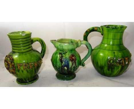 Three Edward Bingham for Castle Hedingham green glazed jugs: One applied with the Tudor rose and 'Drinke Frende'; another 'Ca