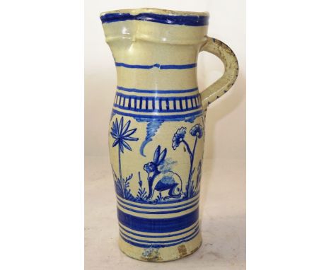 An 18th century Dutch Delftware jug: Of slender ovoid form, the body painted with a continuous hunting scene, within banded b