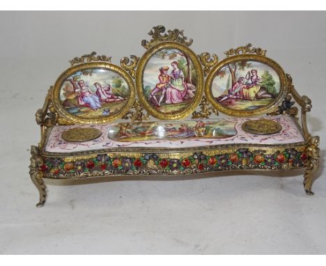 A late 19th century Austrian silver-gilt and polychrome enamel inkstand:
 modelled as a sofa, Vienna, maker's mark SC, circa 